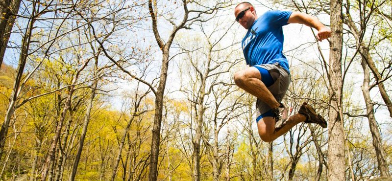 Man jumping and tucking legs beneath himself