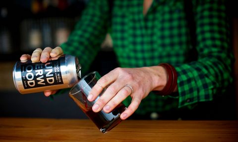 pouring pinot noir into glass from can