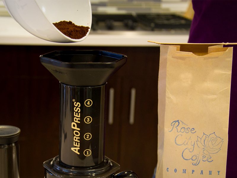 Adding ground coffee to an AeroPress coffee maker