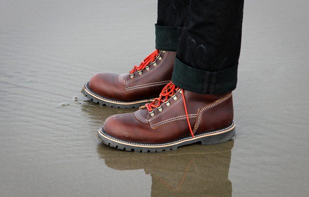 leather hiking boots on the beach