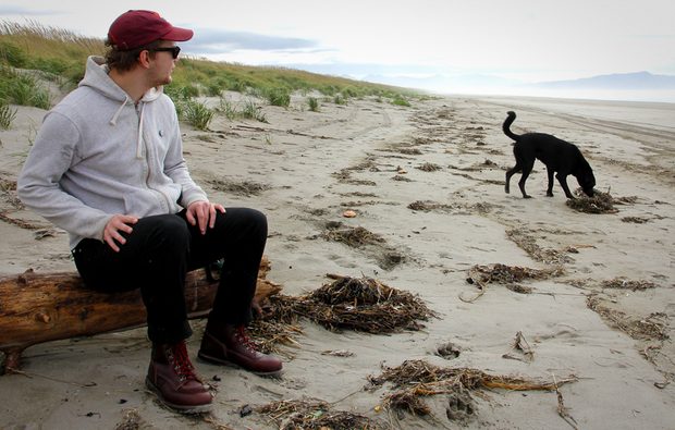 sitting on beach with boots and dog
