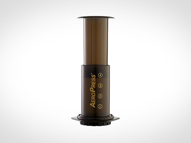 Aeropress coffee maker on a white backdrop.