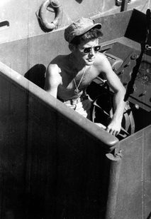 POF/PSF/PT109-1 Lt.(jg) John F. Kennedy aboard the PT-109 in the South Pacific, 1943. Photograph in the John F. Kennedy Presidential Library and Museum, Boston.