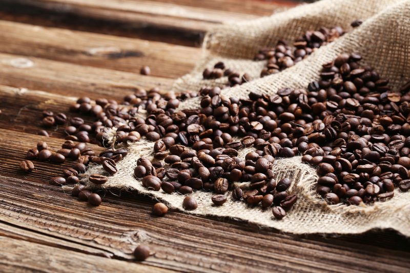 45766910 - roasted coffee beans on a brown wooden background