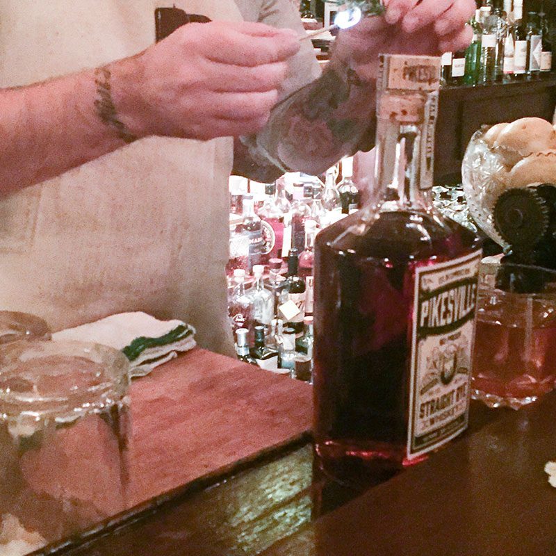 Bartender torching rosemary at PDX Bible Club