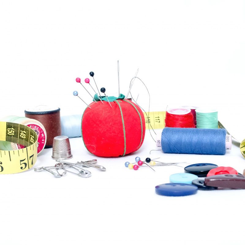 Sewing kit with pin cushion, needles, and thread