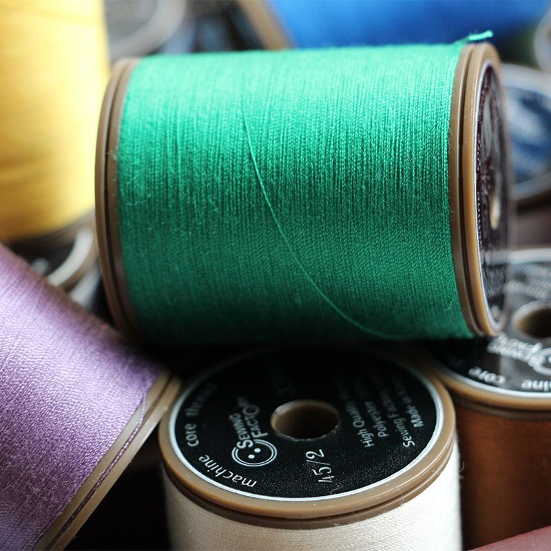 Thread in green, purple, and white