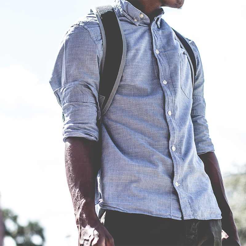 Man with backpack and button-front shirt