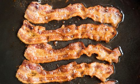 camp bacon ann arbor michigan 44925140  strips being cooked in frying pan close up