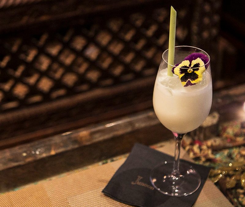 Junoon Coconut Cocktail in a wine glass.