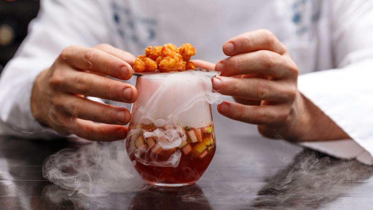 A man making a smoked cocktail.
