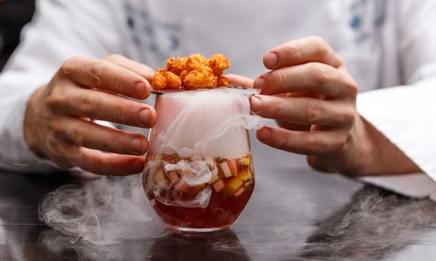 A man making a smoked cocktail.
