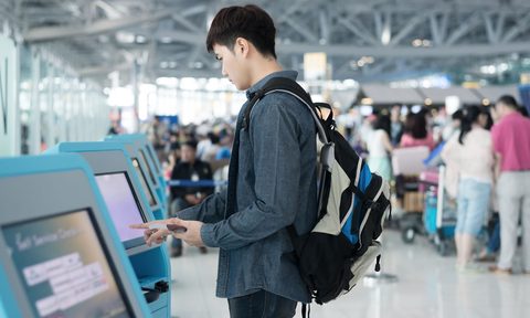 facial recognition, Stock-Man-Printing-Boarding-Pass-at-Kiosk