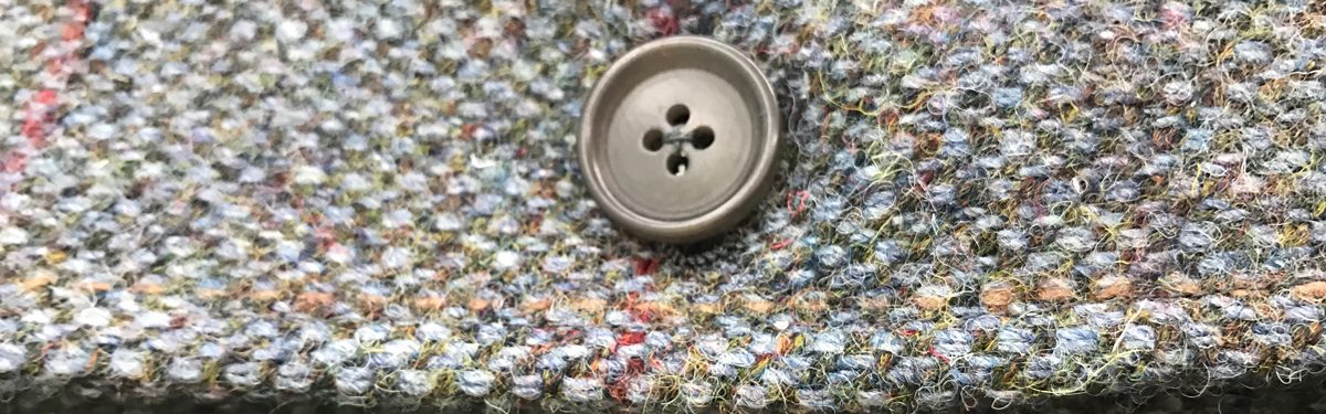 multicolored tweed suit detail with button