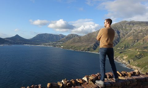 the points guy, man standing on cliff overlooking bay