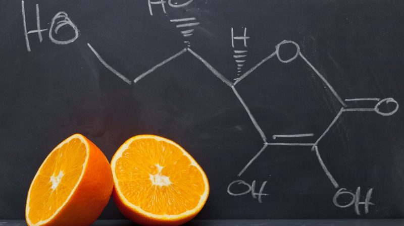Vitamin C, orange, blackboard