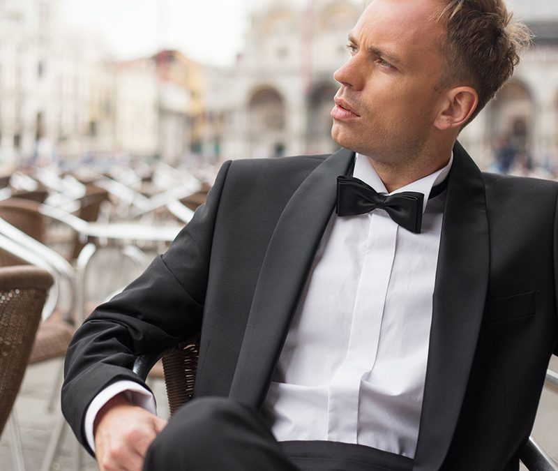Man wearing a cummerbund and tuxedo