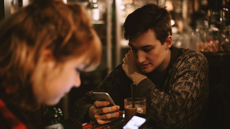 man reading text message