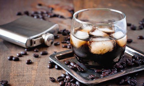 Coffee liqueur in a glass with coffee beans