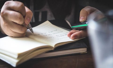 old school travel journal man taking notes