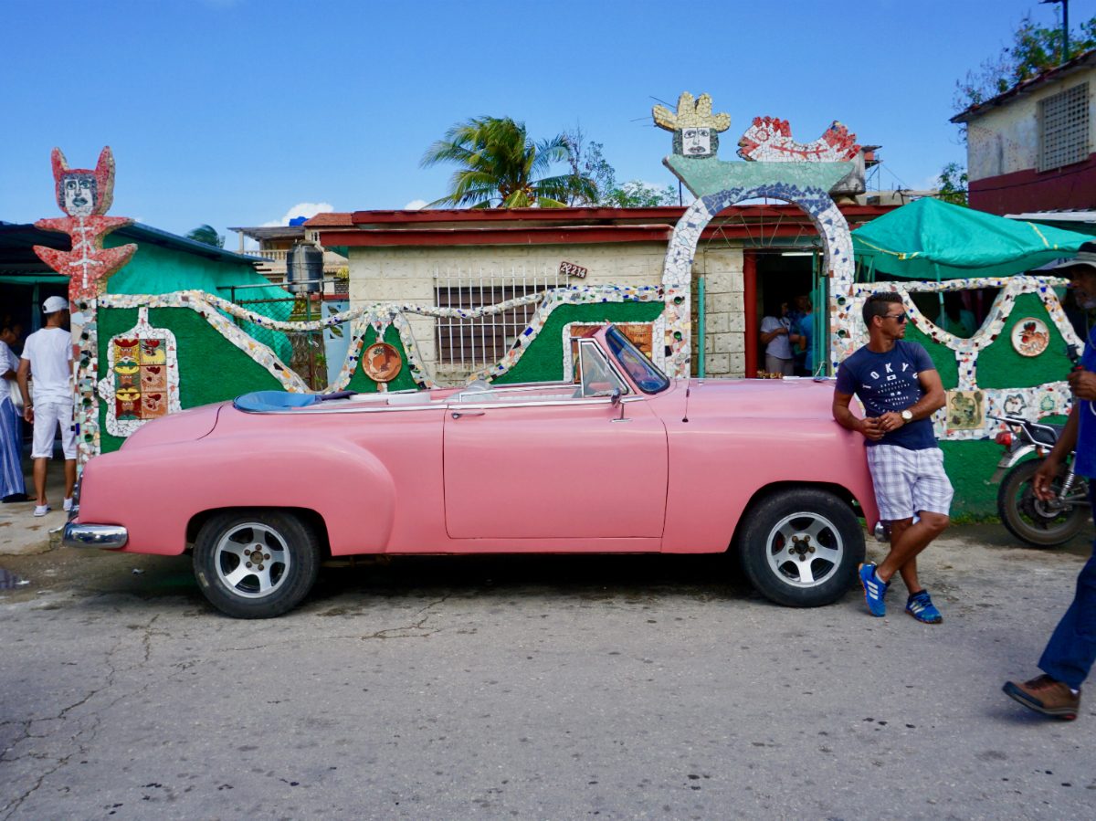 cuban cars pastel pink cuban car with passersby
