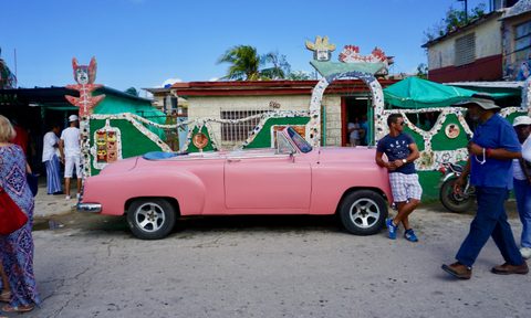 cuban cars pastel pink cuban car with passersby