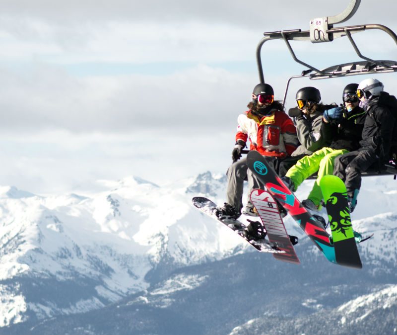Snowboarders on a ski lift