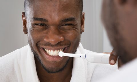 man brushing teeth