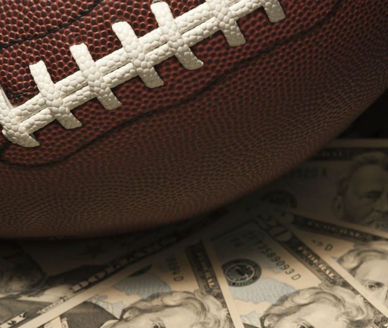 A close-up of a football sitting on cash
