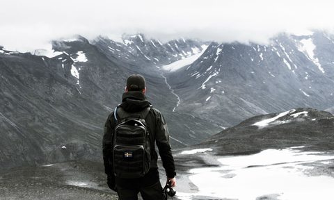 man backpack snow mountain