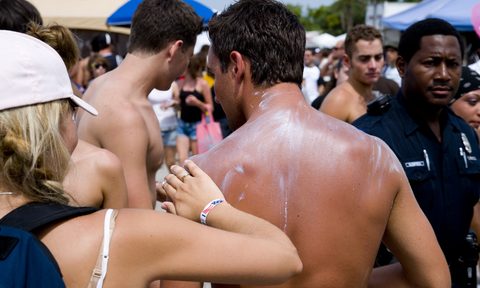 Man wearing sunscreen at a festival