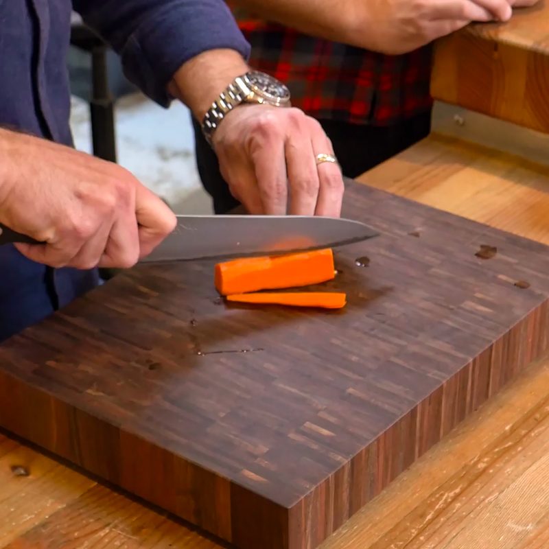 Cutting carrots on a cutting board