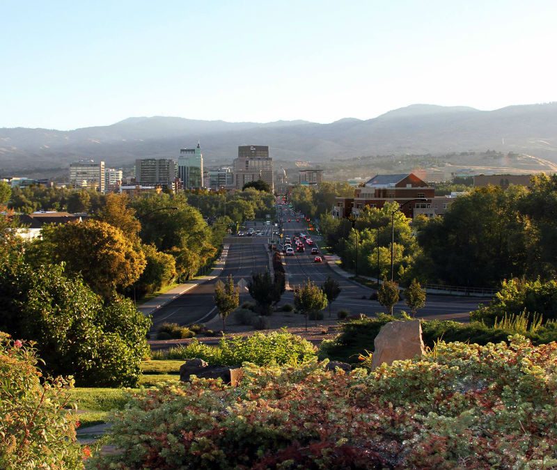 A high-angle view of downtown Boise, Idaho with mountains in the background.