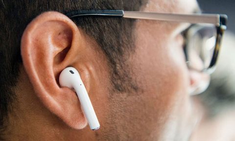 The Apple AirPods in a user's ear.