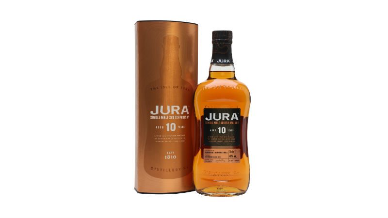 A bottle of JURA 10 YEAR and the copper tin it comes in.