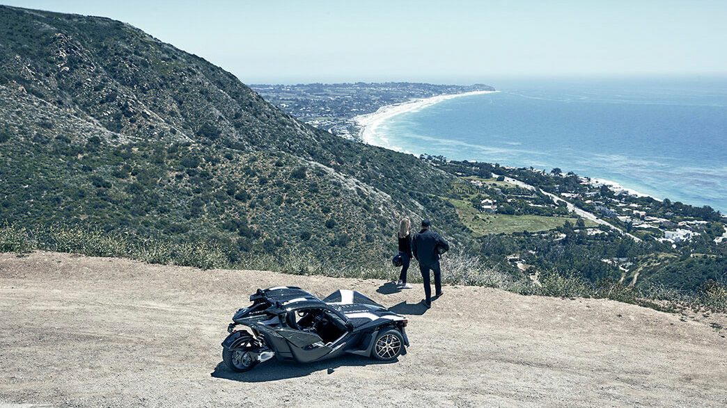 Polaris Slingshot Grand Touring Autocycle racing out of a tunnel toward the camera.