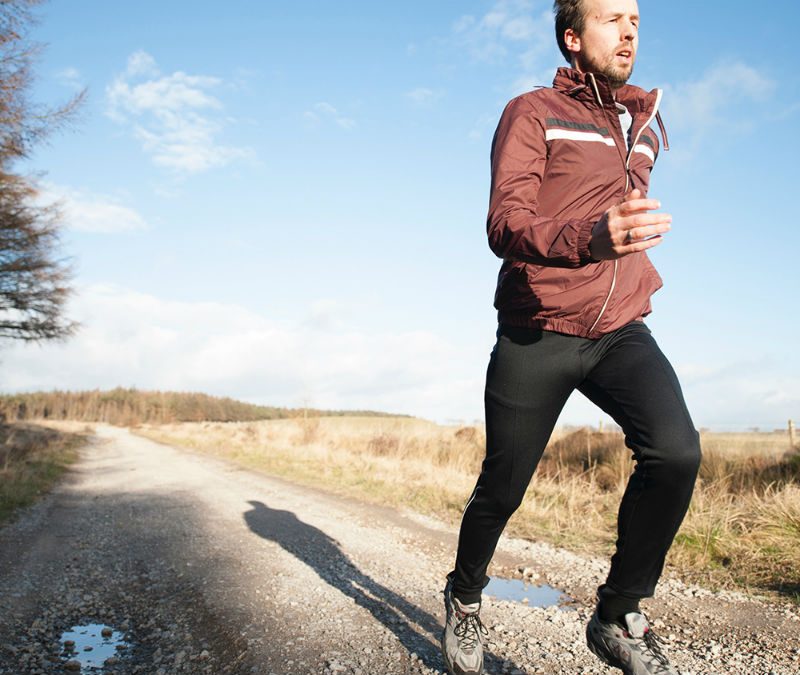 A man in jacket running in the morning.