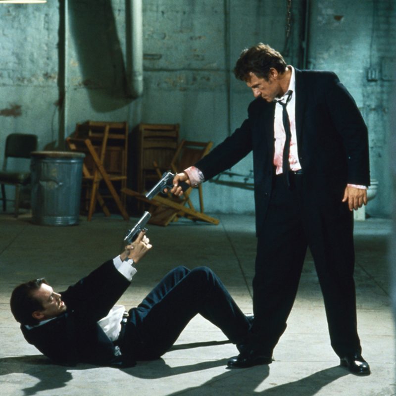Harvey Keitel and Tim Roth point guns at each other in Reservoir Dogs.