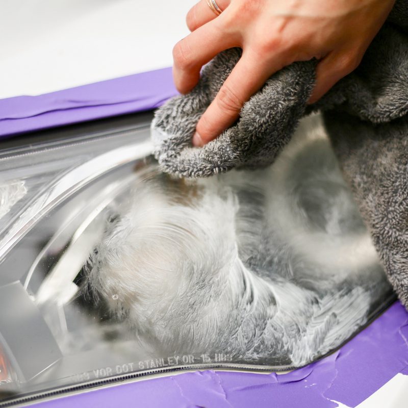 Wiping toothpaste off of front headlight on Toyota RAV4.