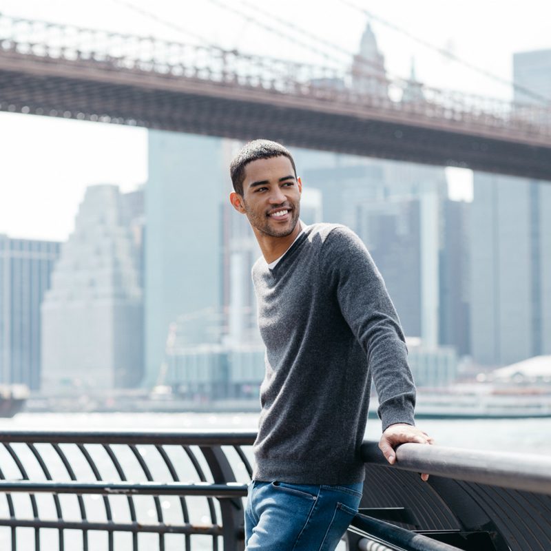 Mott & Bow cashmere sweater on a man in front of the Brooklyn Bridge
