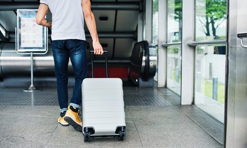 Man pulling his luggage.