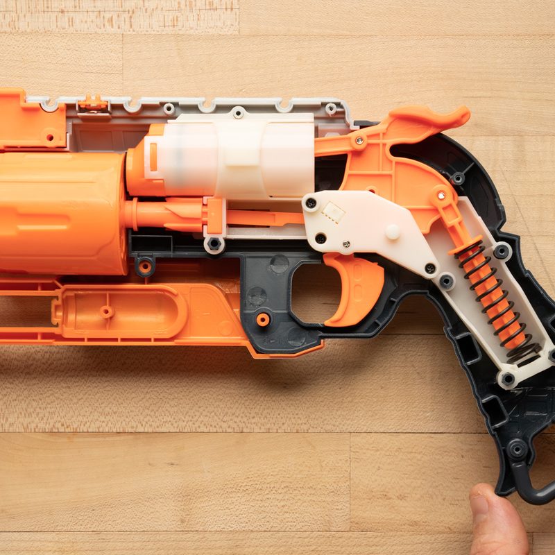 A pair of hands holding the Hammershot wit the trigger mechanism intact.