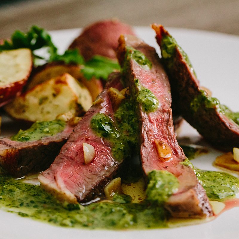 Ribeye Steak Roasted Potatoes with Chimichurri Sauce served on a plate.