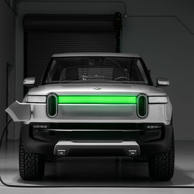 Concept rendering of the Rivian R1T electric truck being charged in a garage.