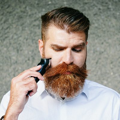 Man grooming his beard and mustache.