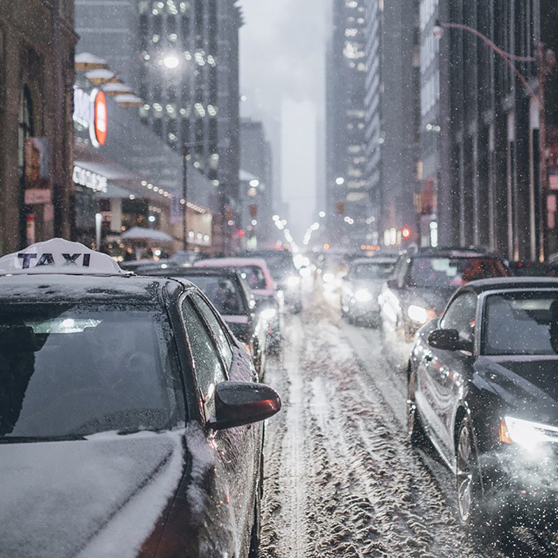 Cars on the street in the winter snow during traffic