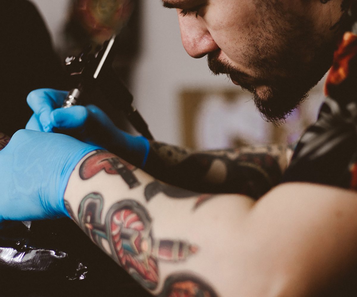man-getting-tattoo-artist