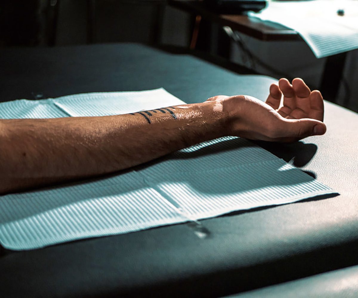man with fresh tattoo aftercare