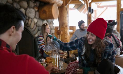 Friend enjoying après ski in a ski lodge