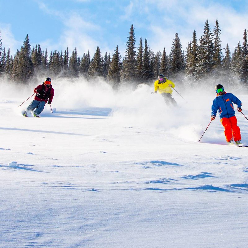 Three skiers on Aspen Snowmass